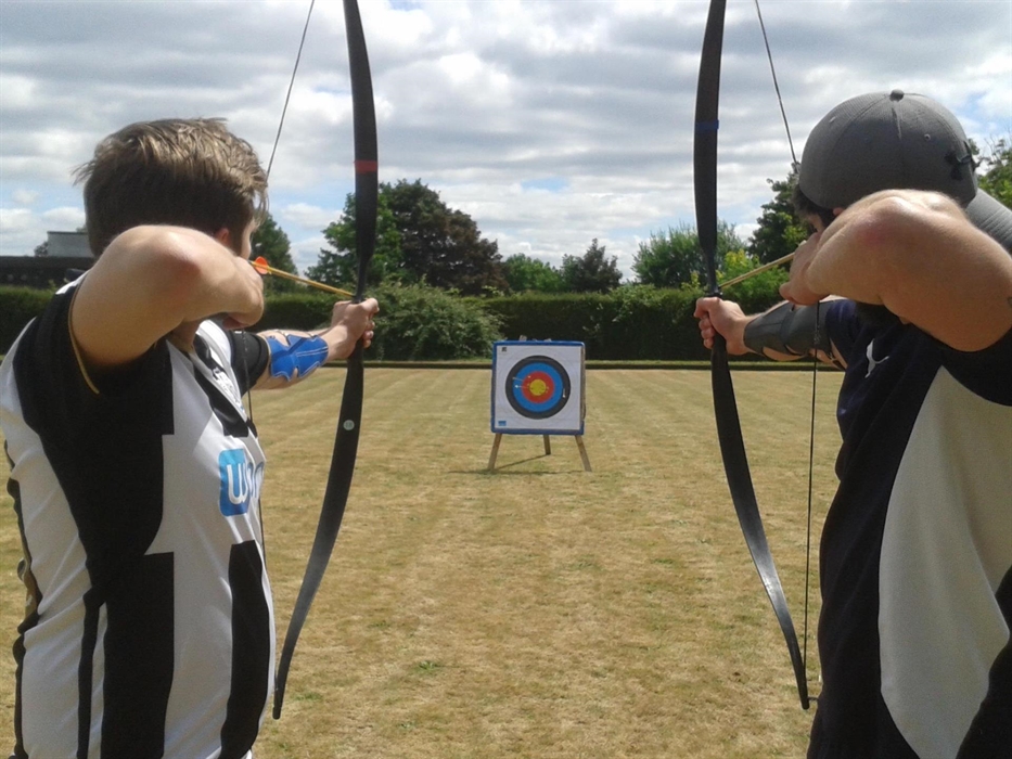 Two people preparing to shoot arrows