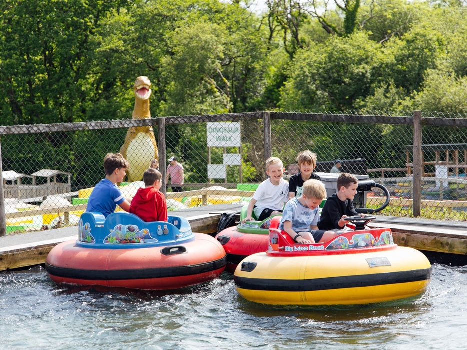Three groups of boys on the disco boats having fun on the water
