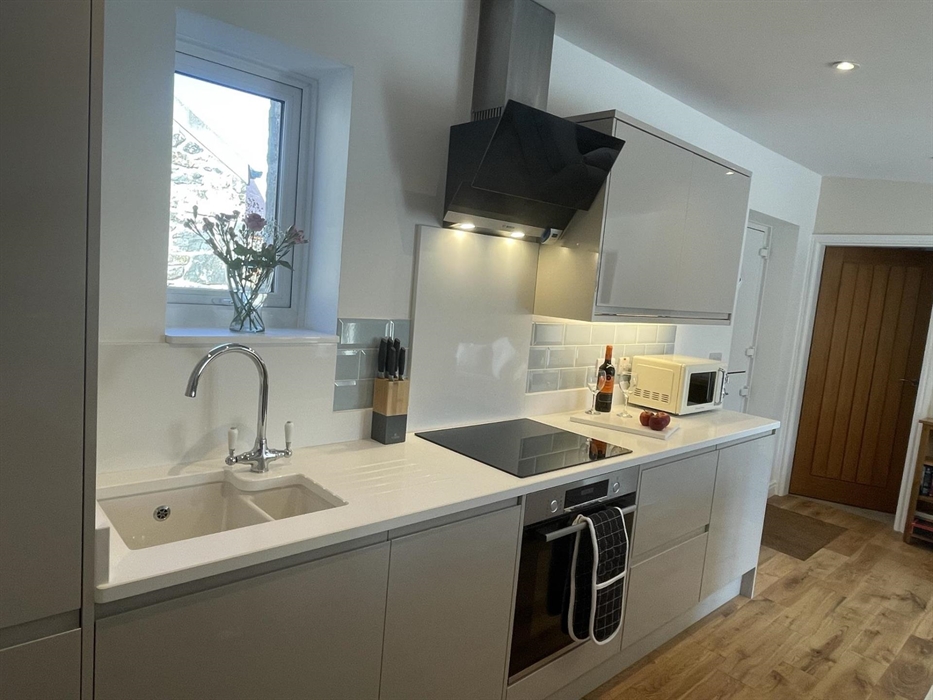 with gloss units, quartz worktop, Bosch appliances & plenty of space for your shopping