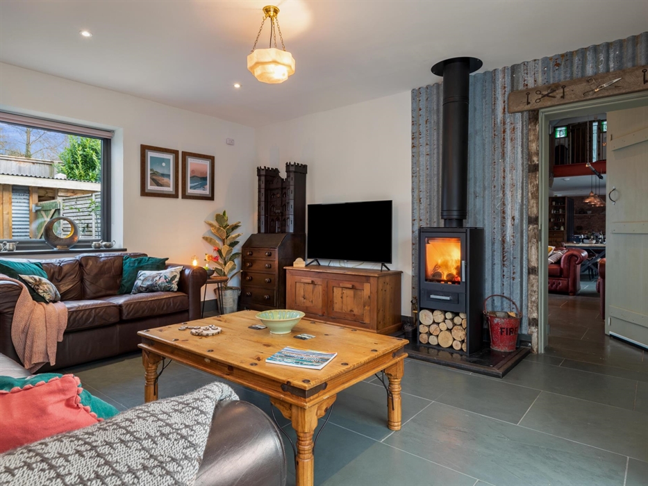 Leather settees in front of wood burning stove. TV with Netflix, WiFi