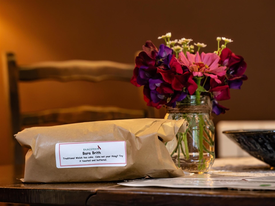 Welcome jar of flowers and home baked loaf of Bara Brith tea cake