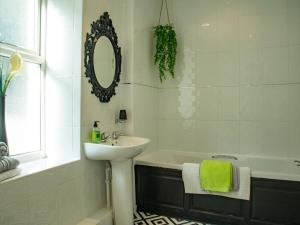 Clean, fresh bathroom with full size bath and corner shower