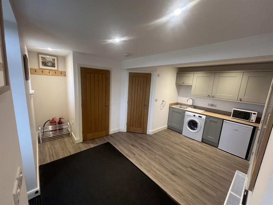 large utility room, washer dryer, microwave and freezer