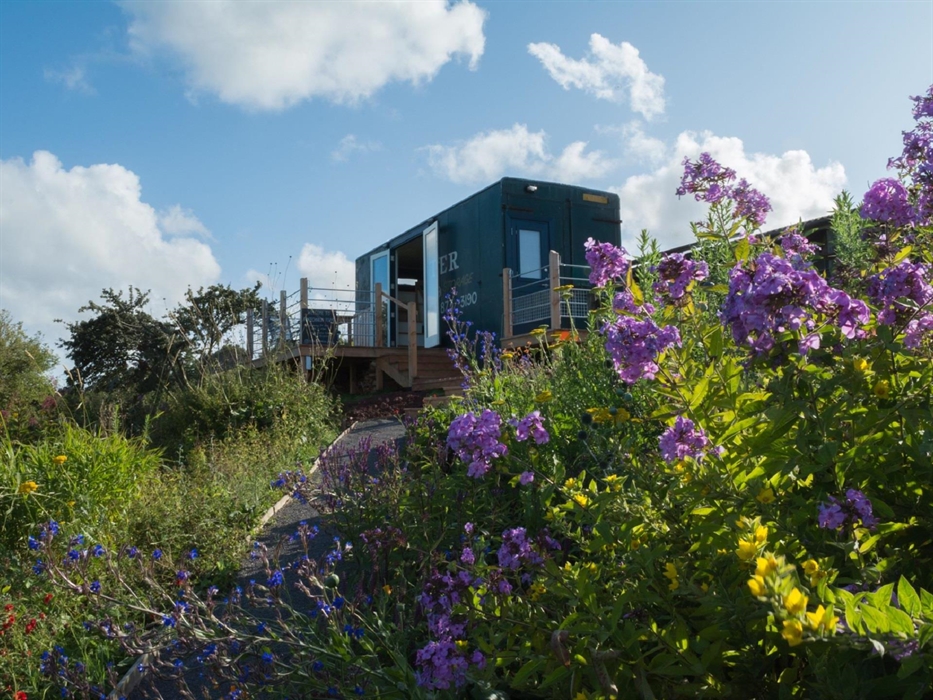 Perched on this wild hillside, surrounded with spectacular gardens.