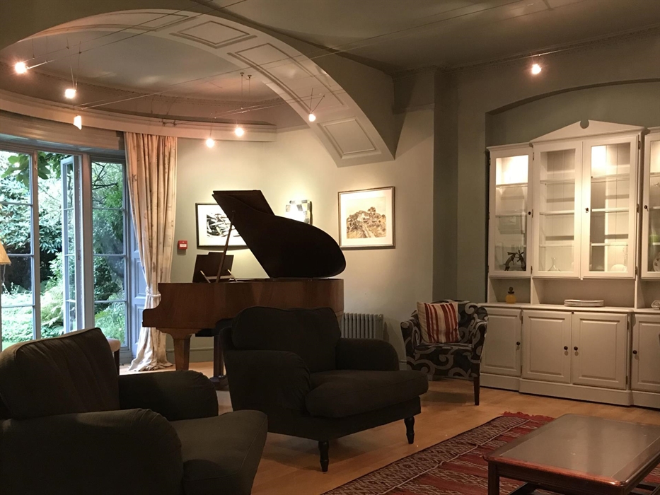 The drawing room seats 20 and has a self playing grand piano