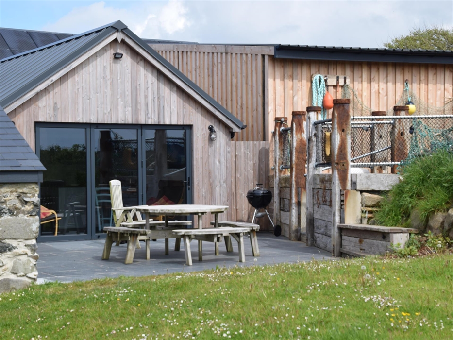 Picnic table on lower level.
Upper patio on the right.