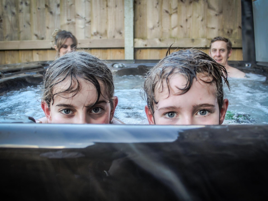 Hot Tub at Glandwr House, Rhayader with a garden surrounding it