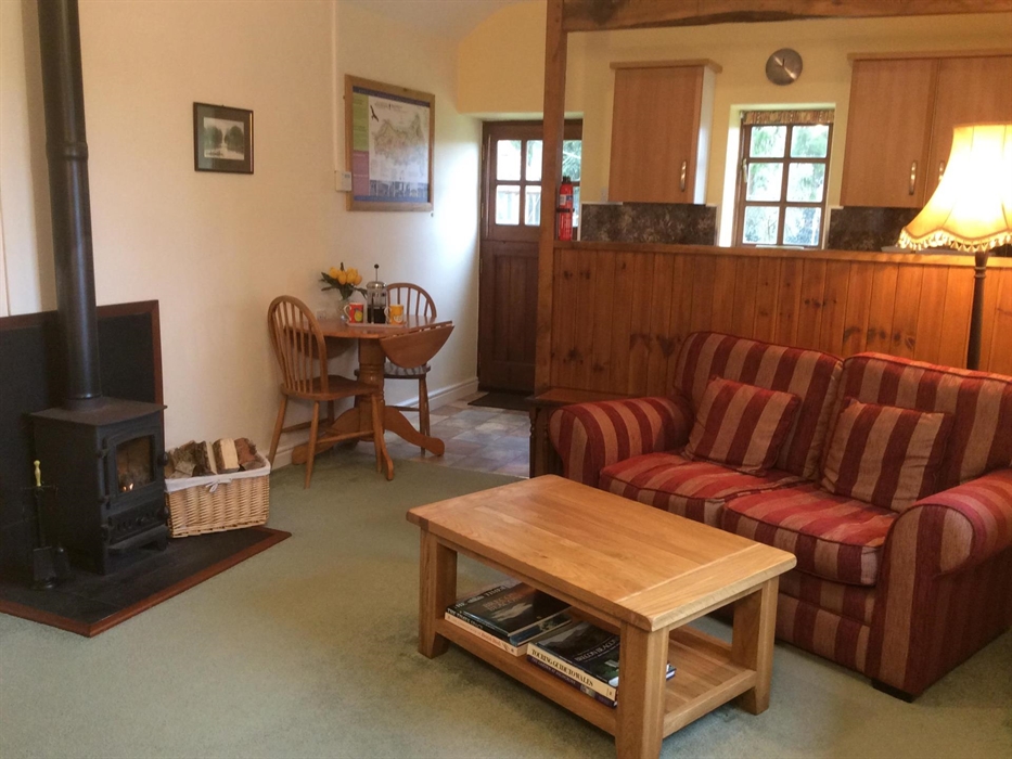 Aberyscir Coach House living room with cosy log burner and excellent WiFi