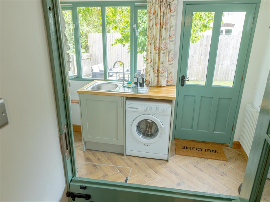 Separate utility with washing machine and downstairs toilet.