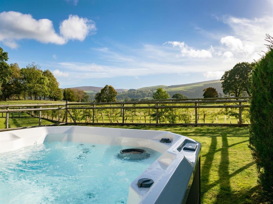 A private hot tub with views over the dee valley
