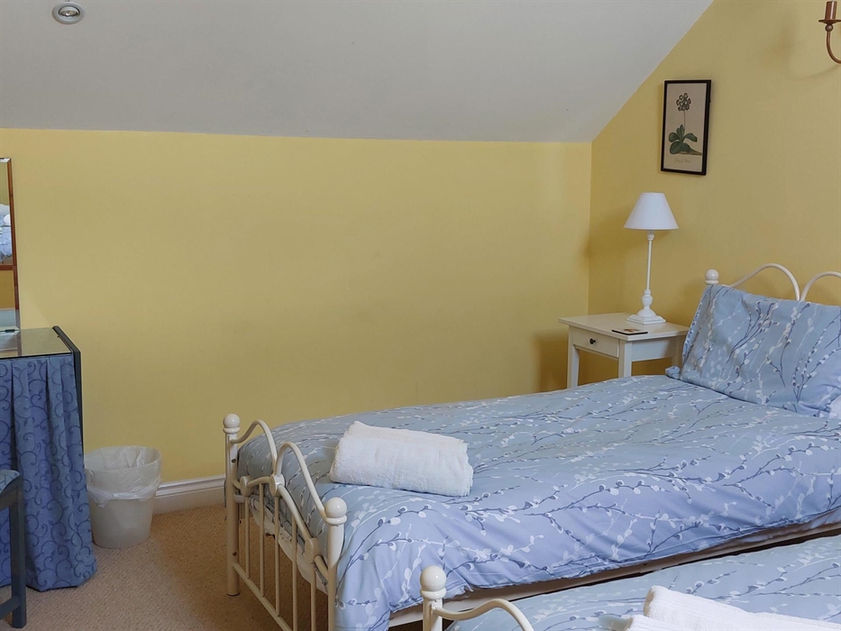 Twin bedroom with ensuite bathroom with bath, shower over, loo, basin and shaver point