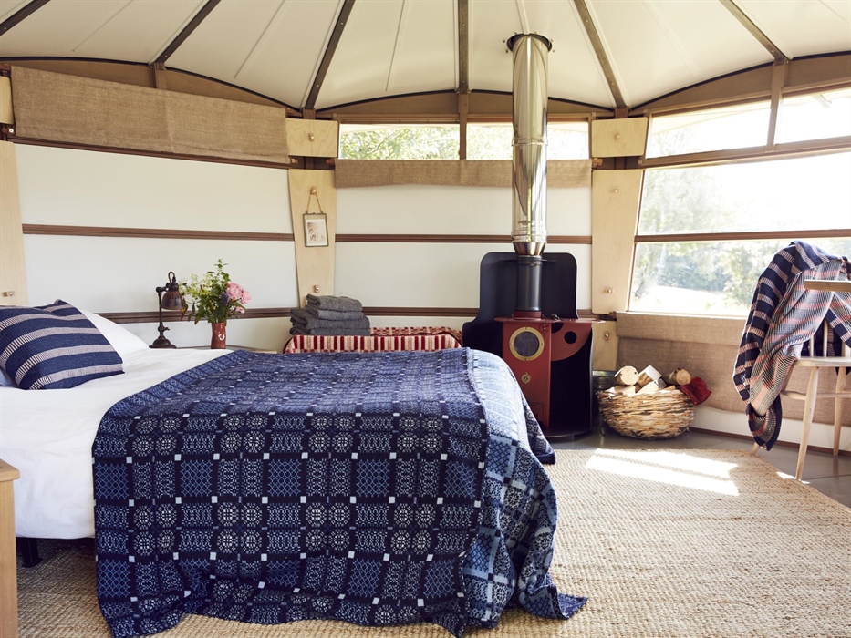 Cwtch up beside our Chilli Penguin Wood Burning Stove, sleep in a double bed with cotton sheets, electric blanket, duvet and Melin Tregwent’s wonderfu