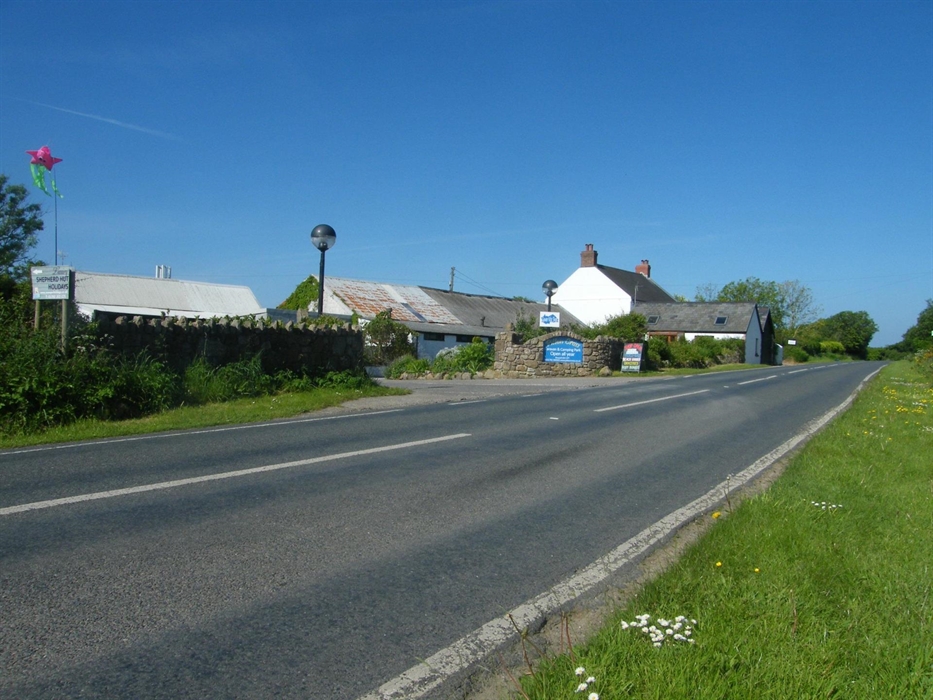 We are on the B4247and 2 miles from Scurlage on the left