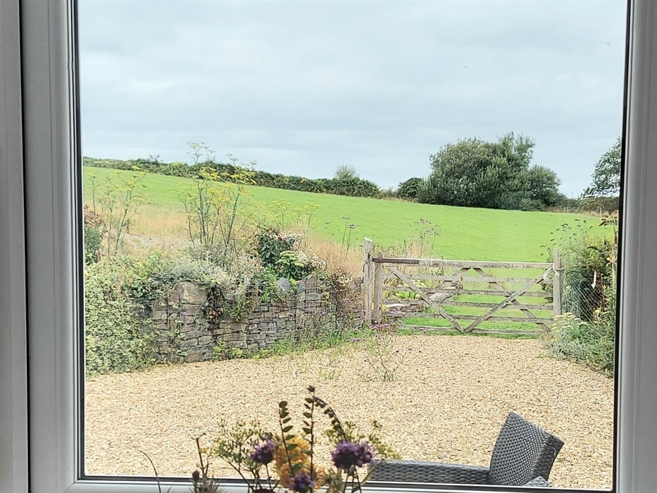 Lovely view of the meadow, gardens and large private back yard beyond the patio