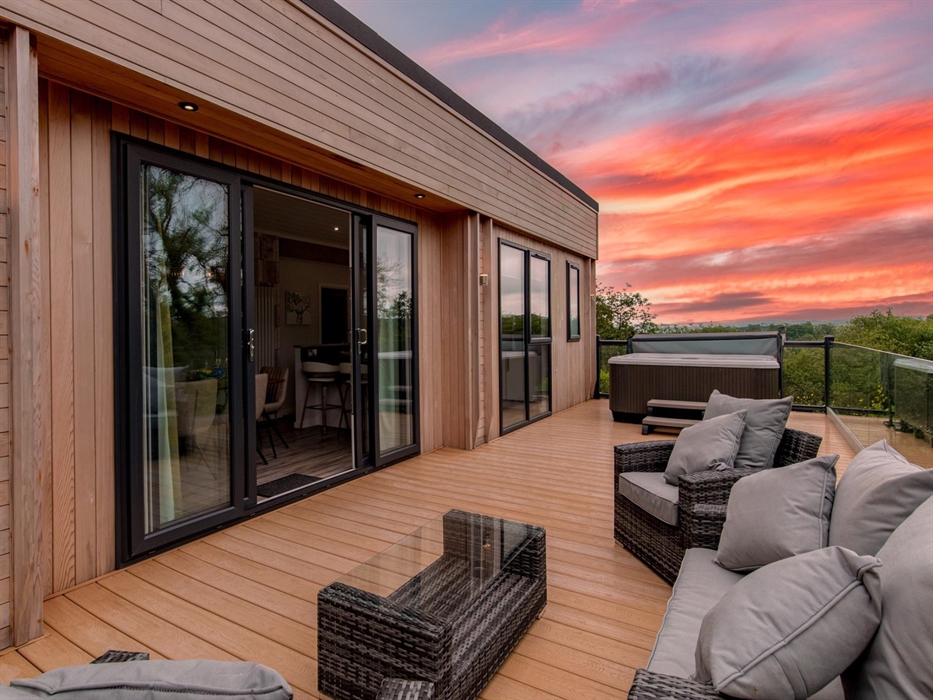 Taken at sunset with view of hot tub and dining areas.