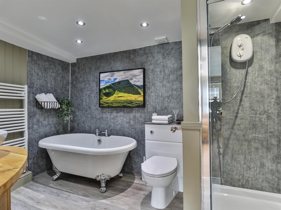 The ensuite in the mini suite has a roll top bath and separate walk in shower, towels, face cloths, make up remover flannel, bath soak, room spray, lu
