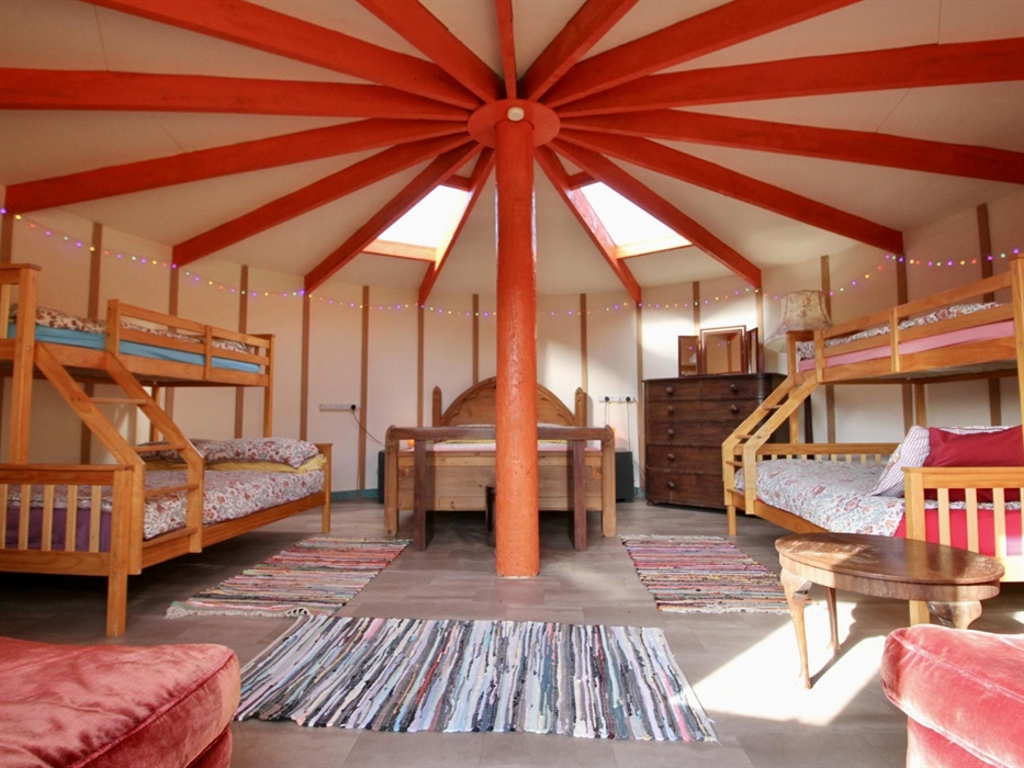 Yurt Axana sleeps up to 8 guests in a king bed and two triple bunks (single over double beds).