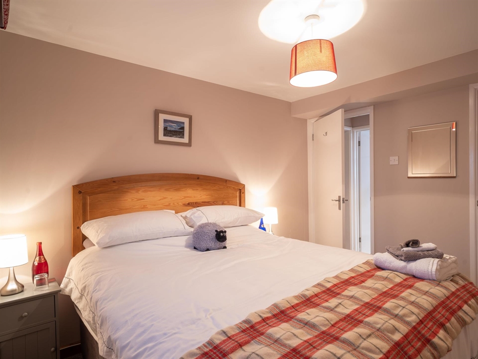 On the ground floor opposite the bathroom.  A king-size bed