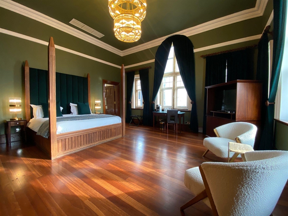 The Rajah of Sarawak suite boasts a huge four-poster bed, two comfy chairs and small coffee table, an additional table and chair and large television,