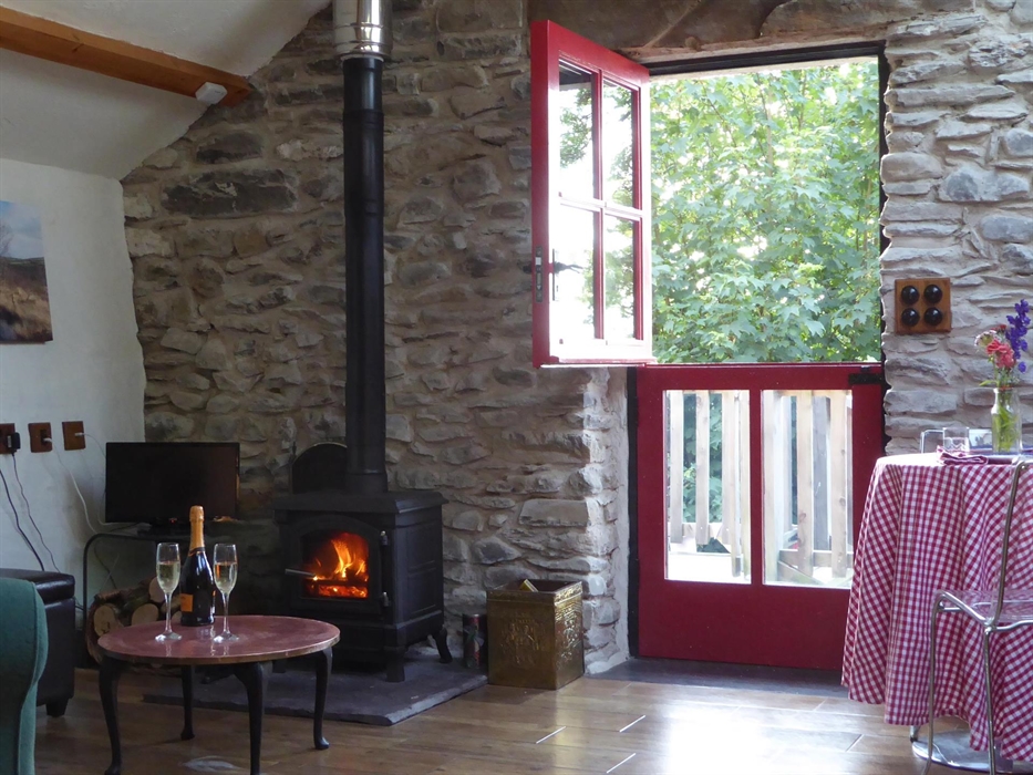 Relax with a glass of bubbly in front of a wood burning stove fire, stable door open
