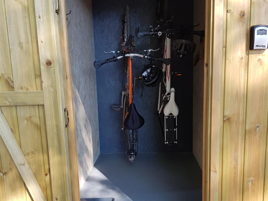 bikes hanging up on hooks in a storage area
