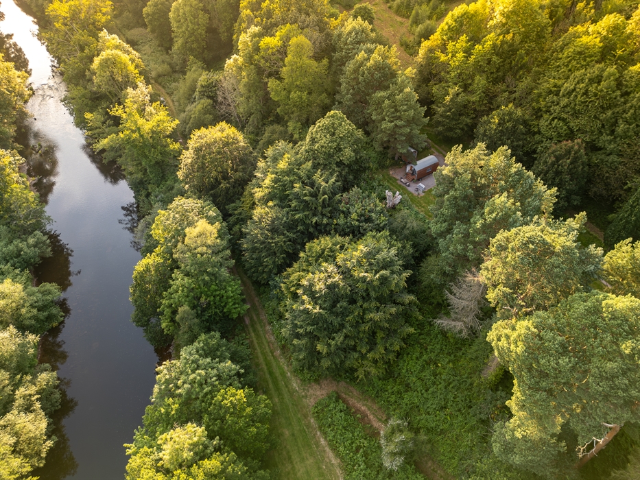 birds-eye view of The River Usk running through Glanusk country estate surrounded by beautiful parkland and trees.  the oak retreat accommodation pod