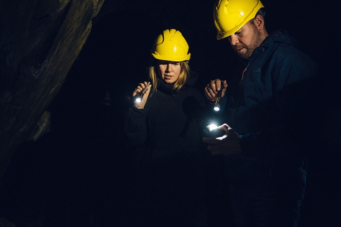 A man and lady with hand torches