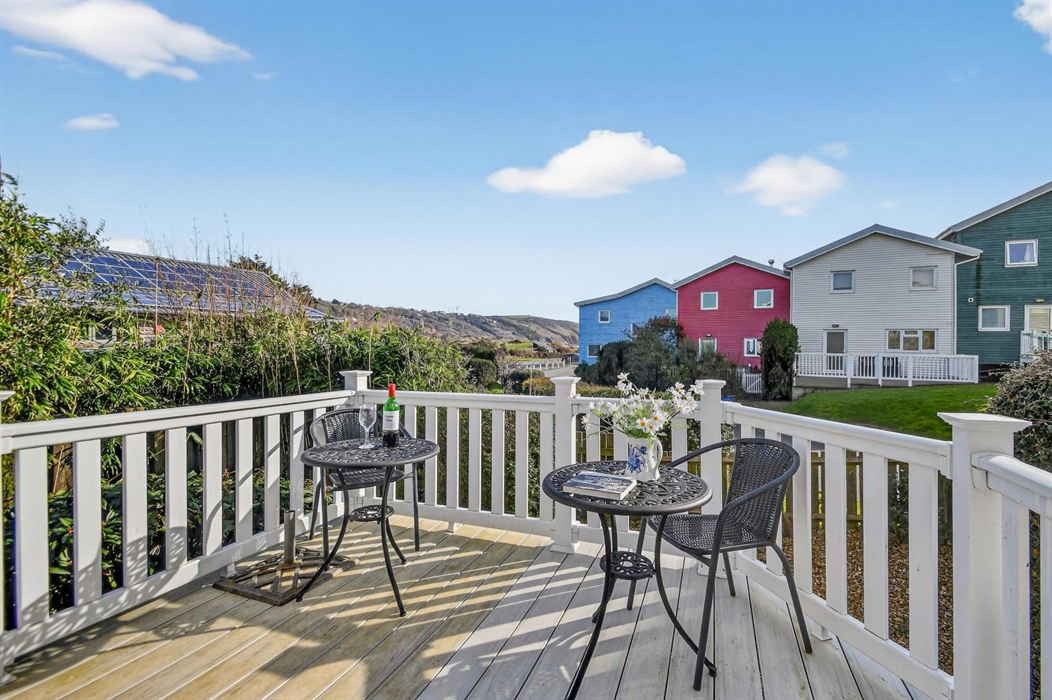 Showing our extended deck. We have three cafe type tables and 8 chairs.