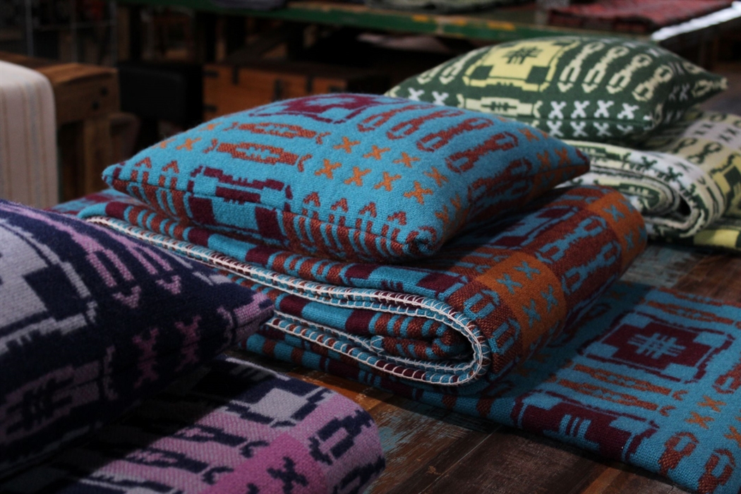 Colourful woven patterned blankets and cushions