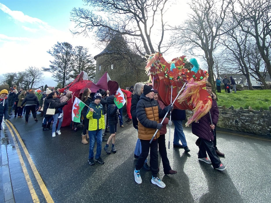 St David's Day parade in Wales featuring traditional dragon procession and Welsh flags