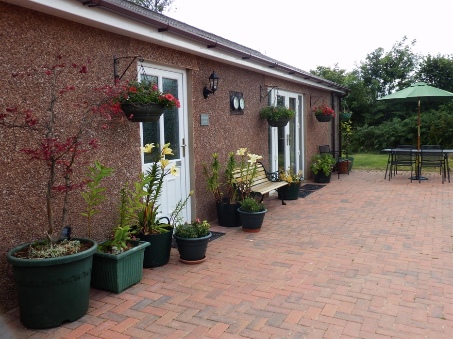 detached bungalow with private jacuzzi area to the side of the property