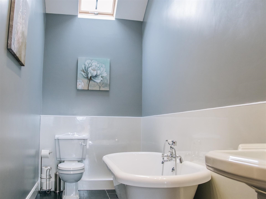 Separate bathroom with bath tub.