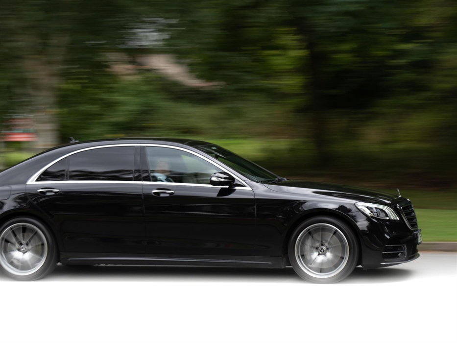 Black chauffeur driven Mercedes S-Class