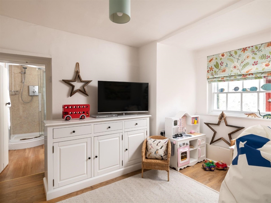 A joy for all parents. Toys that are new to children, plenty of games, books and dvds as well.

The downstairs bedroom uses this shower room.