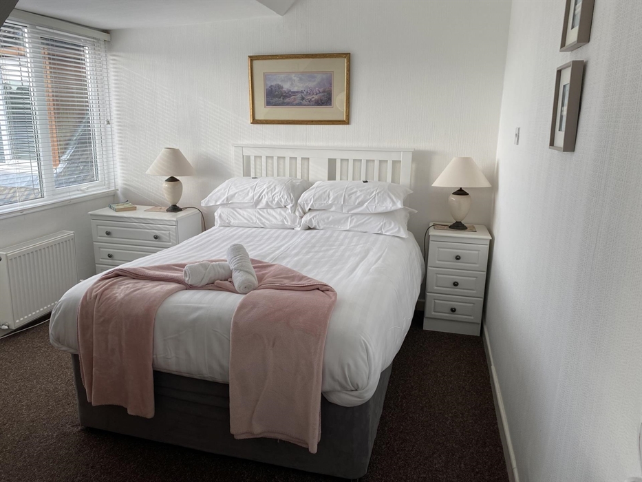 Ensuite, spacious bedroom with its separate sitting area to unwind, ample dressing table area and comfortable double bed.