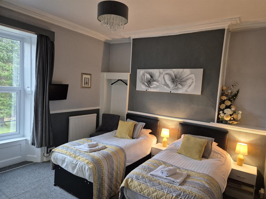 Twin room first floor with mountain views and tall ceilings.