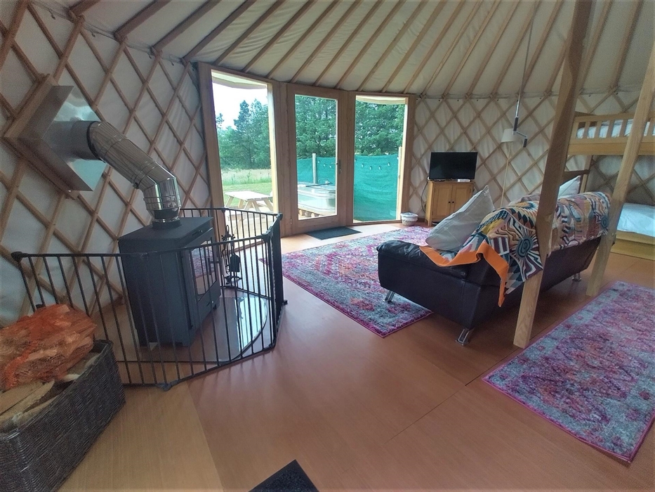 Luxury Yurt, with wood burner, sofa, bunk beds, king size double bed, smart TV and stunning country views through the full height window