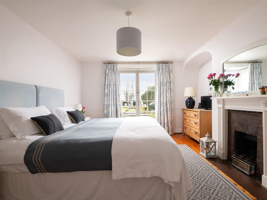 A downstairs bedroom with French doors to open onto the garden and a shower room.  A great way to enjoy a multi-generational holiday.