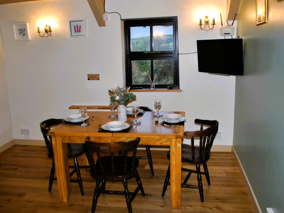 Co-located with the kitchen the dining room comfortable seats four people. It boasts its own Smart TV and is adjacent to the main bedroom.