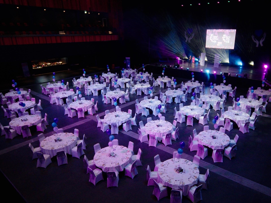The auditorium floor set up as a banquet.