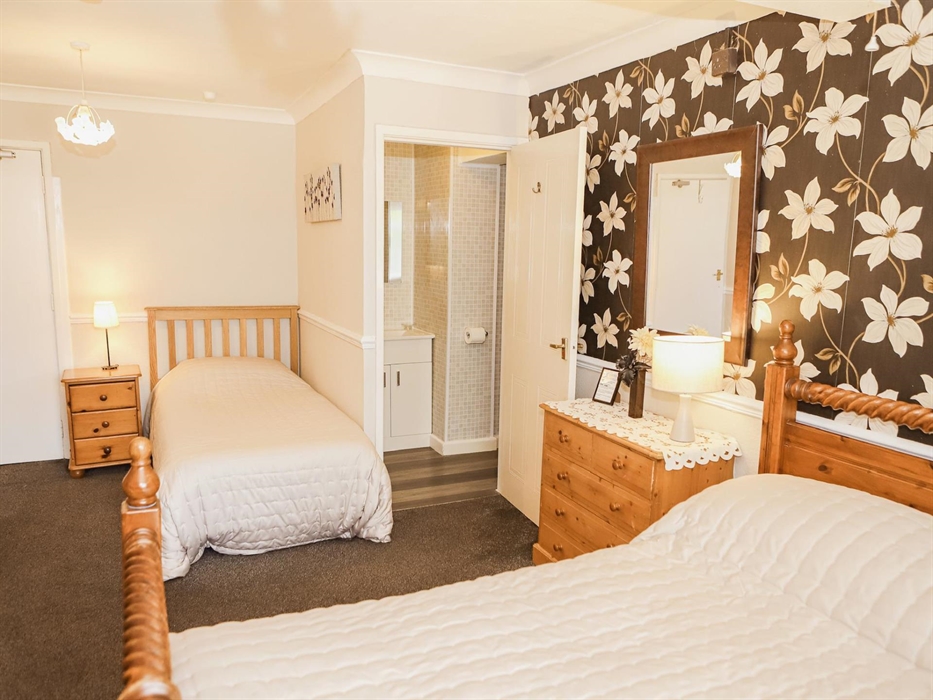 Family bedroom with cot and private facilities