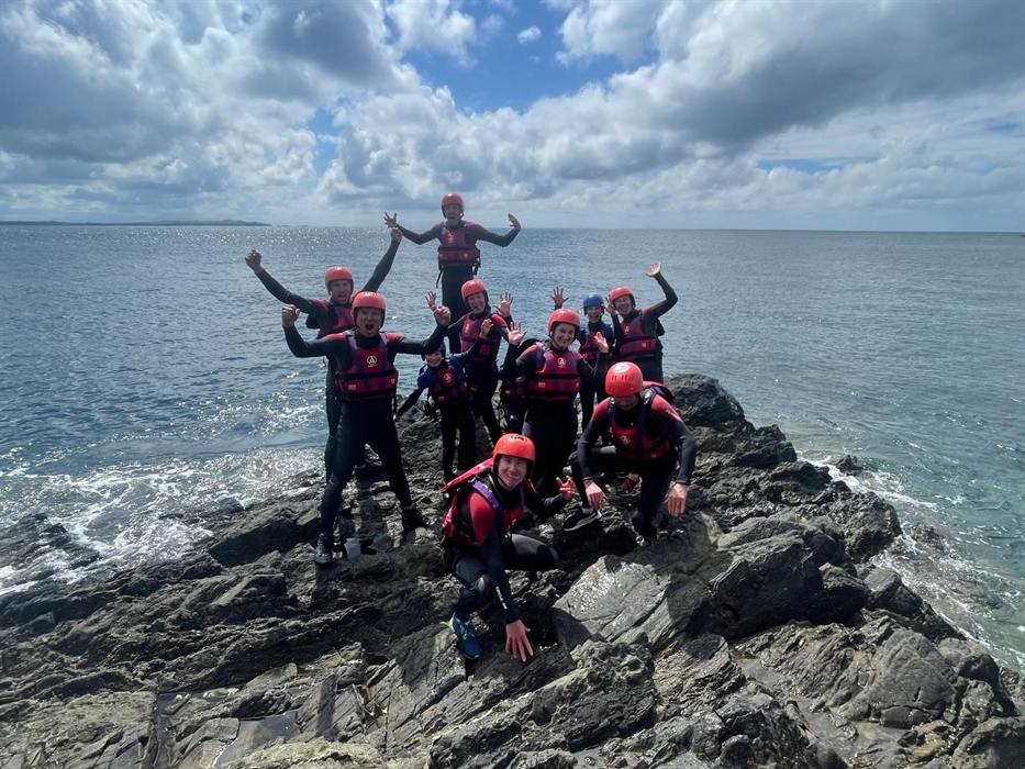 Bearded Men Adventures, People on rocks on the welsh coastline coasteering