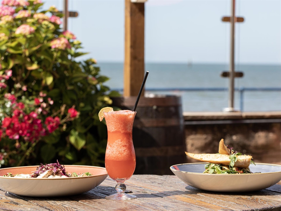 Chicken Salad and Cavolo Nero Pasta with a cocktail on our Promenade Terrace, overlooking the Irish Sea.
