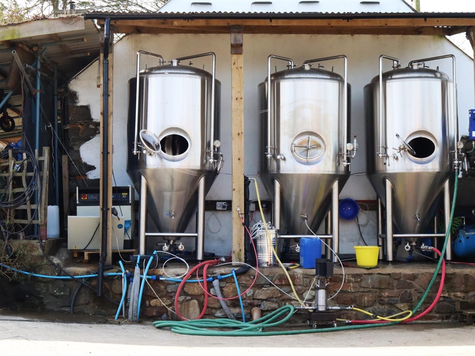 Three fermenters outside of the Brewery.