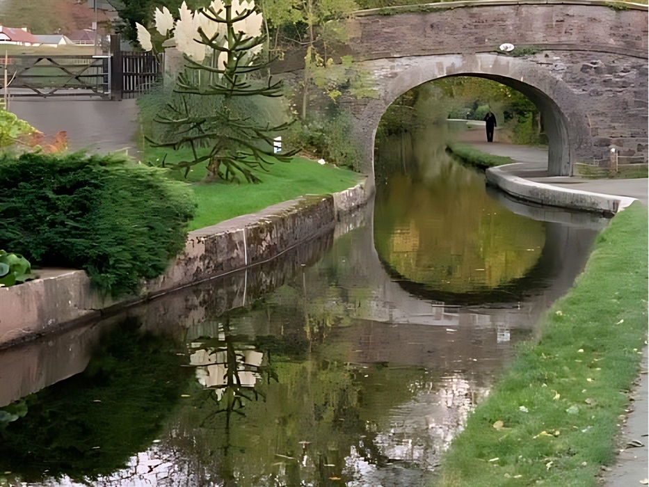Scene of one of Llangollen Canal's historic stone bridges and the beautiful scenery on the canal side.