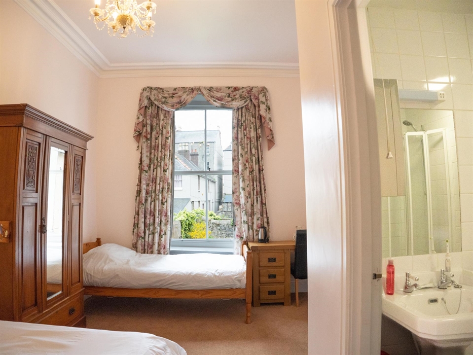 Double and single beds, desk, en-suite bath with shower over and wc.  This is my favourite room in the hostel, pink and pretty.  It has a beautiful ch