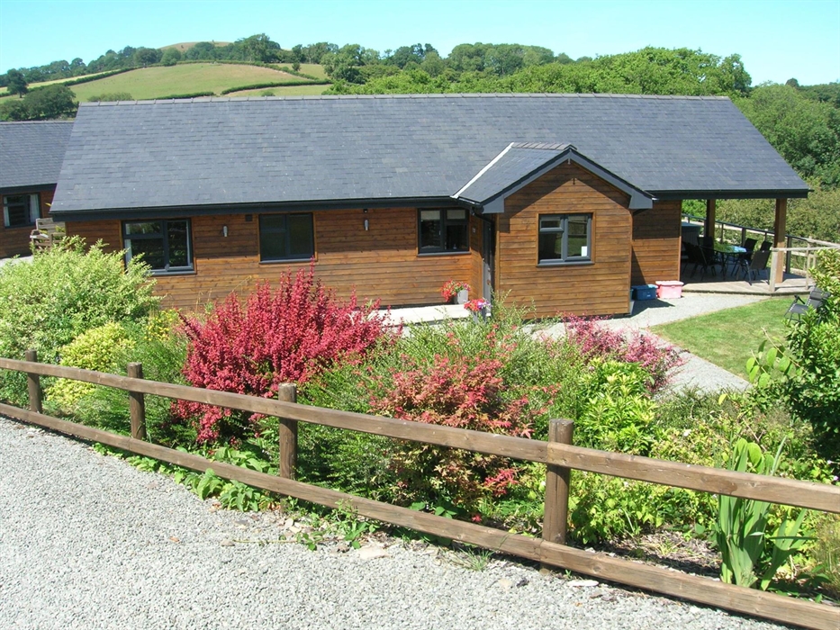 Undercover Hot tub on decked area at the back of the lodge.