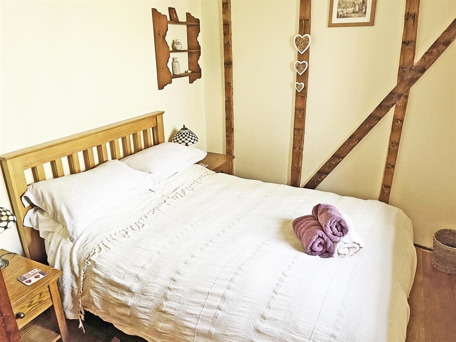 The double bedroom has a double bed, wardrobe, bedside tables and lamps, heater.