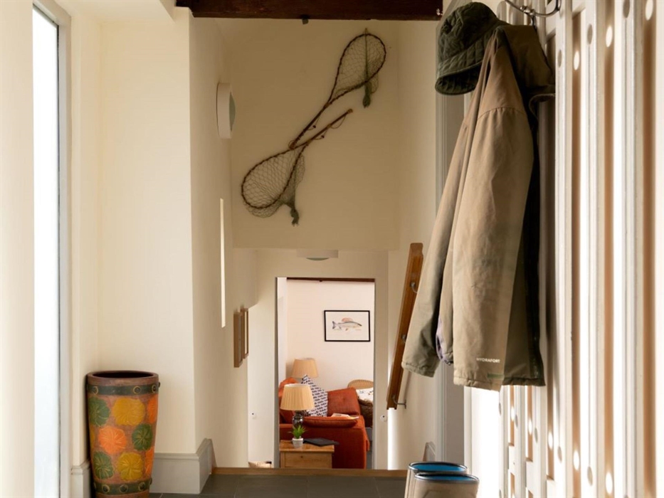 The entrance hallway with two sets of steps down into the living space