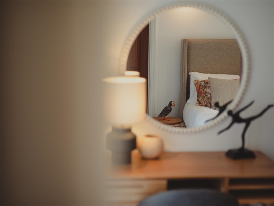 A graceful desk/dressing table provides a serene spot for morning preparations or penning down vacation musings.